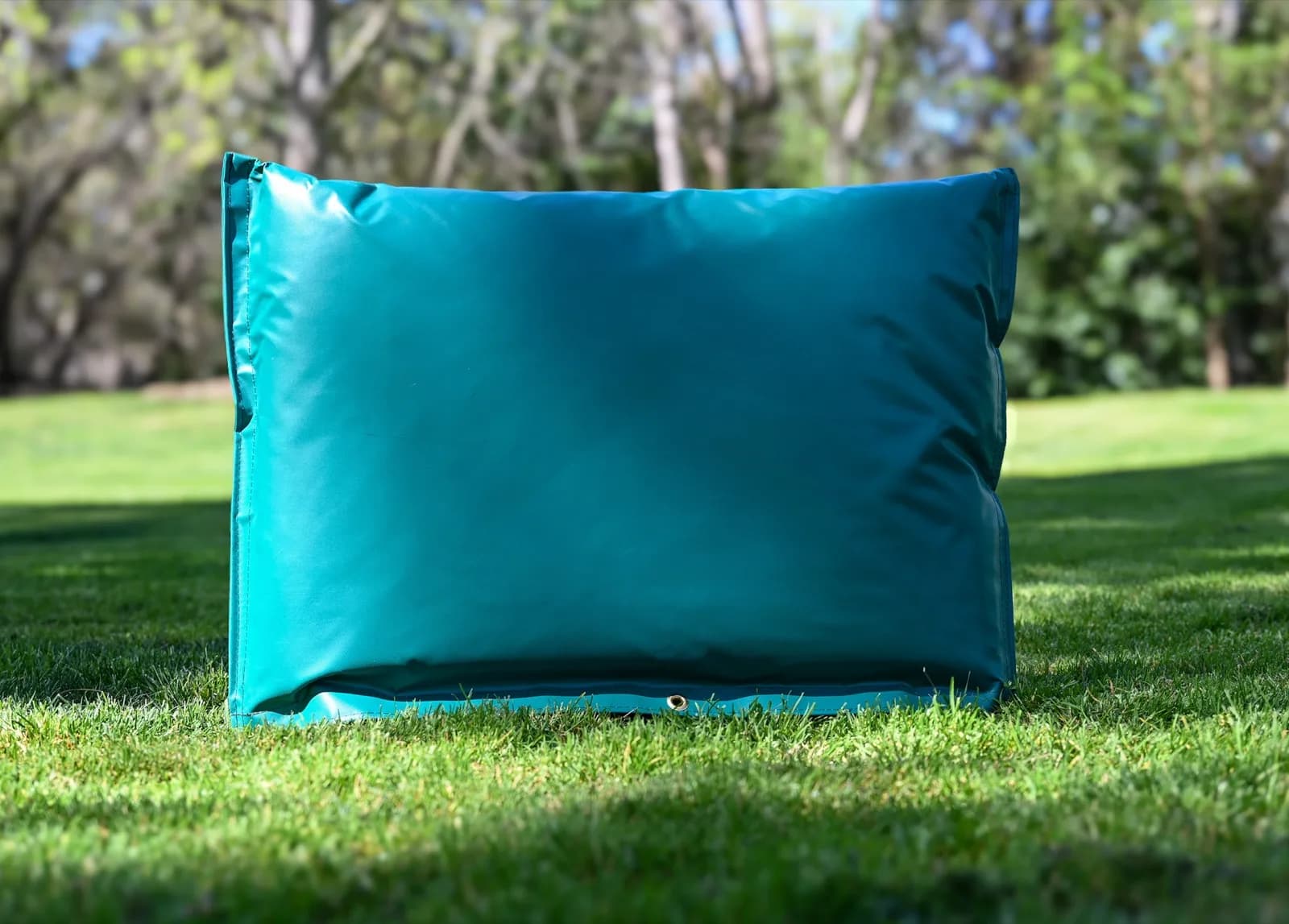 Green 30 by 24 inch closed-top insulated backflow cover standing on grass, with the brass lock grommet visible at the base.