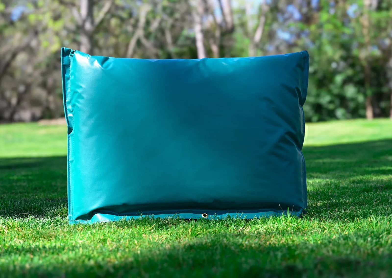 Green 36 by 24 inch closed-top insulated backflow cover standing on grass, with the brass lock grommet visible at the base.